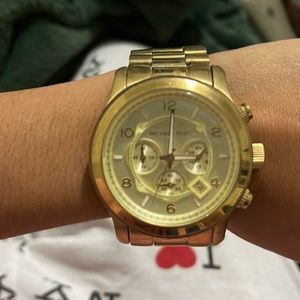 A gold Micheal Kors Watch